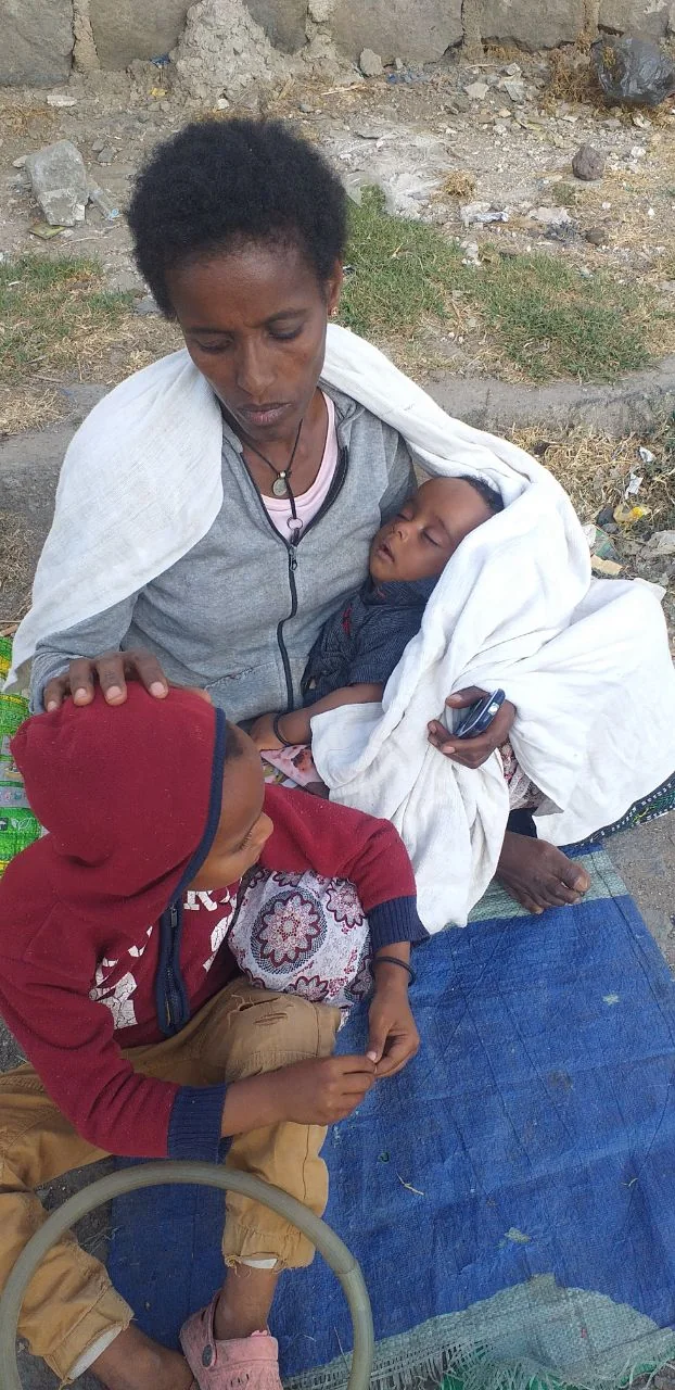 A mother and children together outdoors